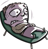 a frightened man lying on a deck chair